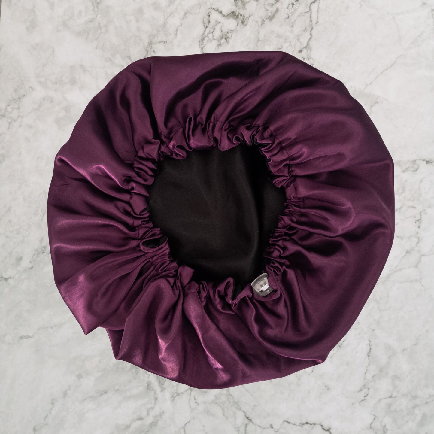 Hair Wrap Heaven STAY ON satin bonnet with adjustable elastic - Purple flat image with black lining
