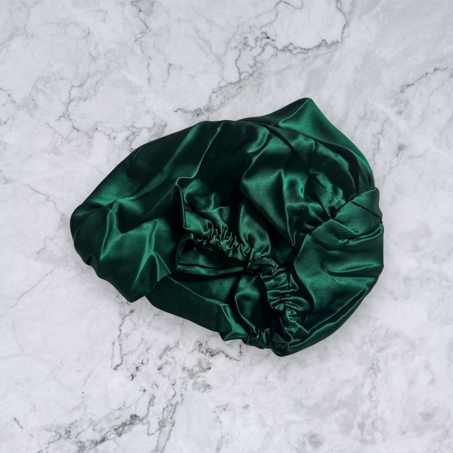 silk bonnet with twist detail to front elastic to back - dark green rear view