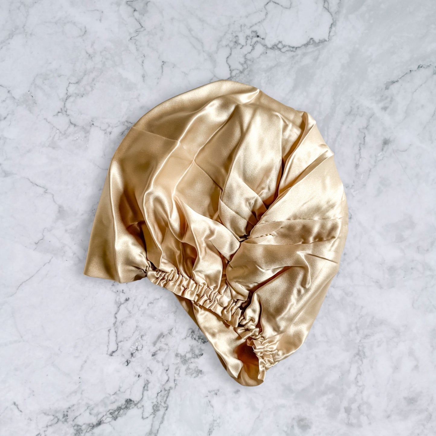 silk bonnet with twist detail to front elastic to back - champagne nude rear view