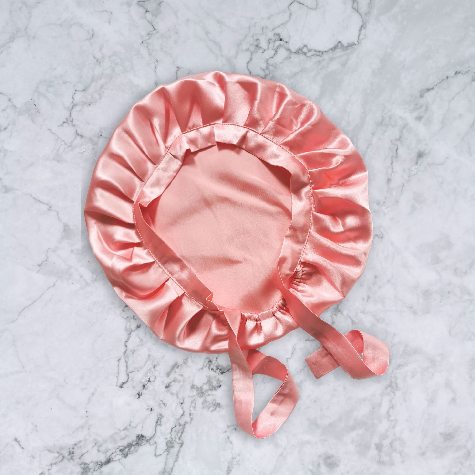 Silk bonnet with ties - rose gold flat view
