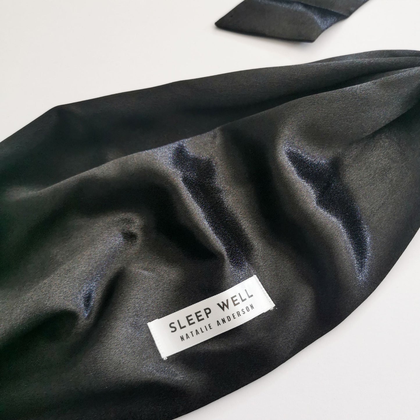 black satin hair wrap with sleep well label