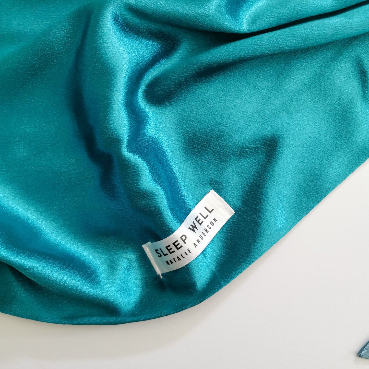 satin hair wrap with white sleep well label peacock teal colour