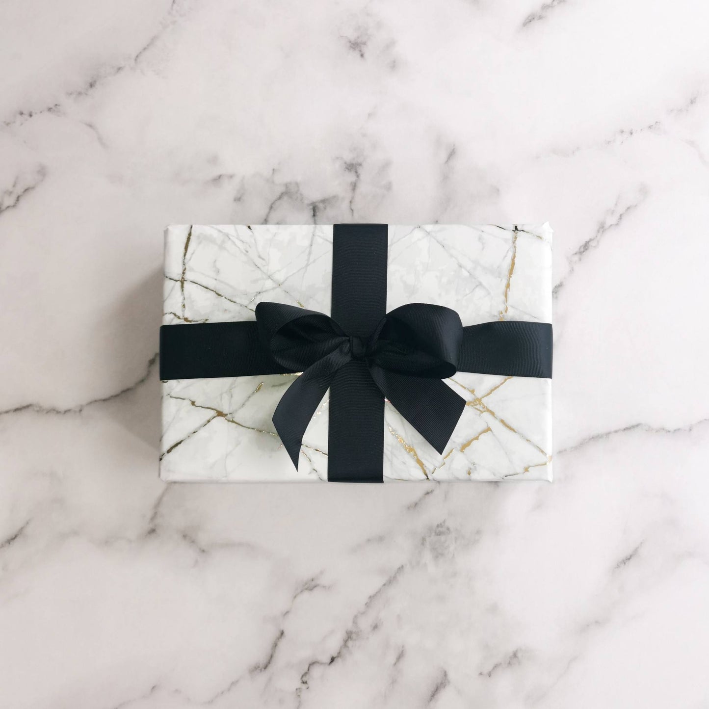Natalie Anderson gold flecked, marble wrapping paper with black grosgrain ribbon - large