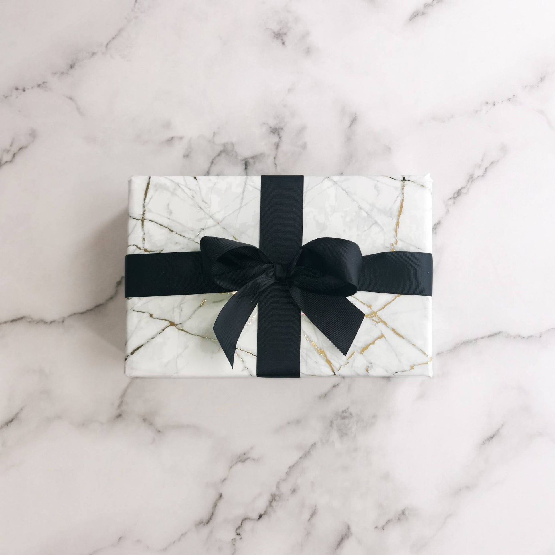 Natalie Anderson gold flecked, marble wrapping paper with black grosgrain ribbon - large