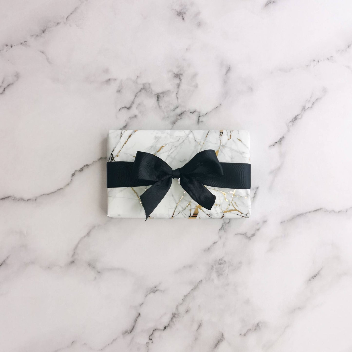 Natalie Anderson gold flecked, marble wrapping paper with black grosgrain ribbon - standard size