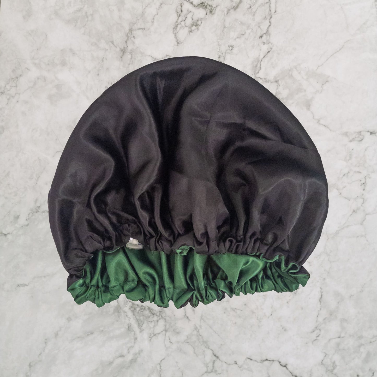 Hair Wrap Heaven vegan silk satin bonnet with adjustable elastic - reverse image with black outer and bottle green lining