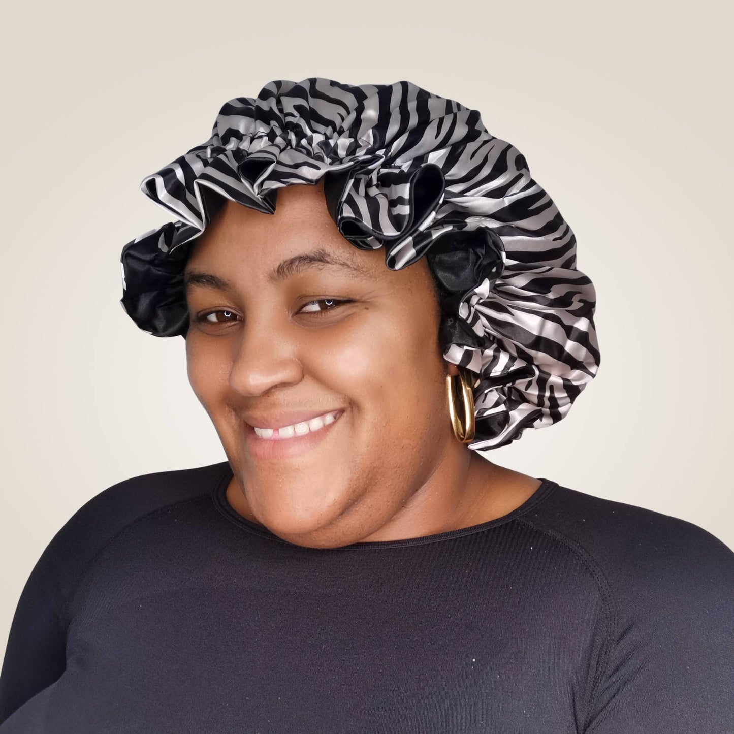 zebra print satin bonnet with frill finish and black lining - model view