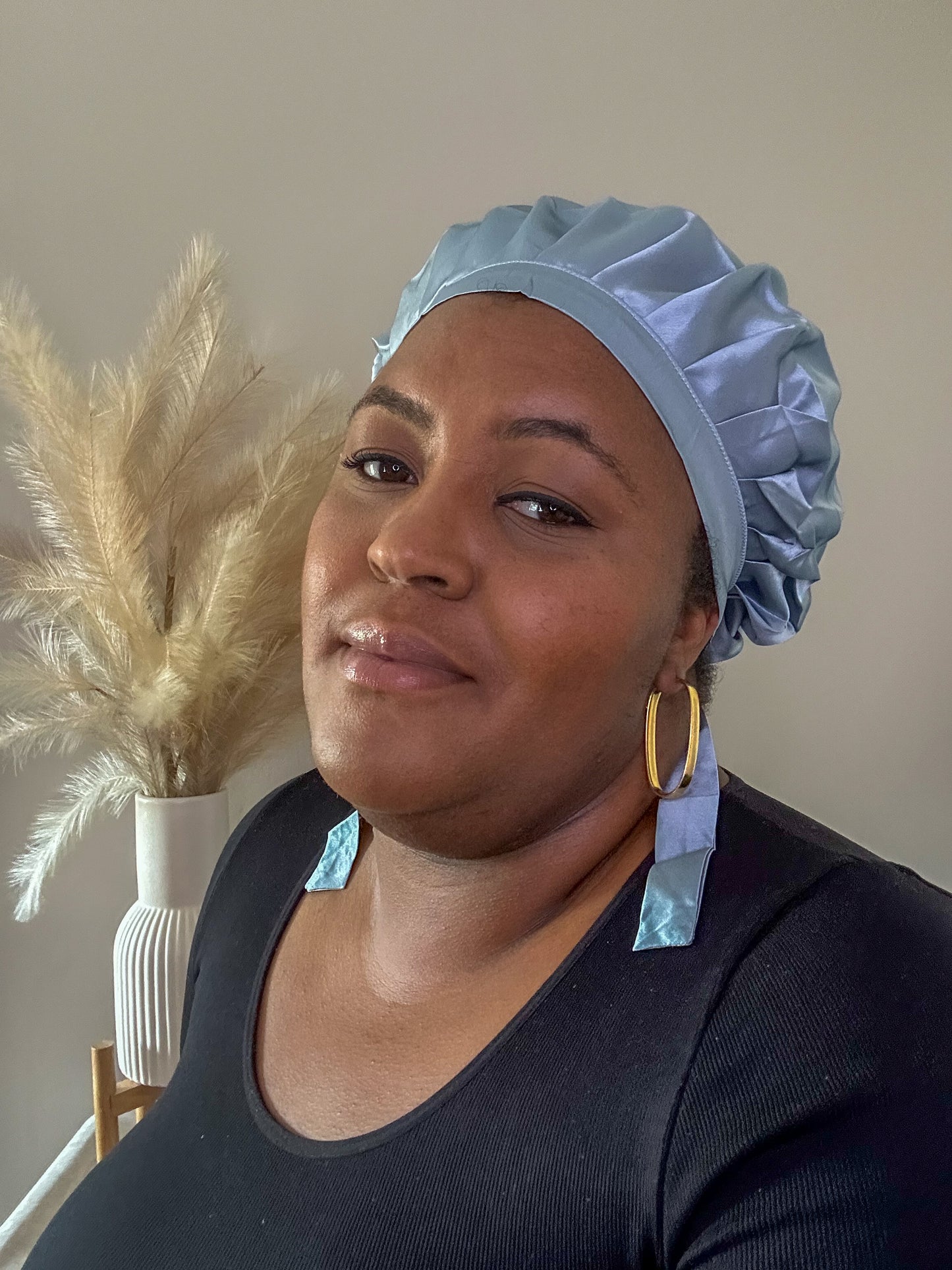 silk bonnet with hair wrap ties - blue grey colour on black model pampas grass in background