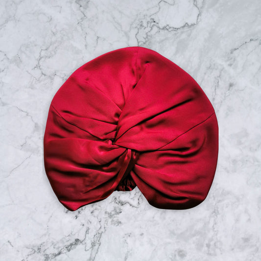 Red silk turban on a marble surface