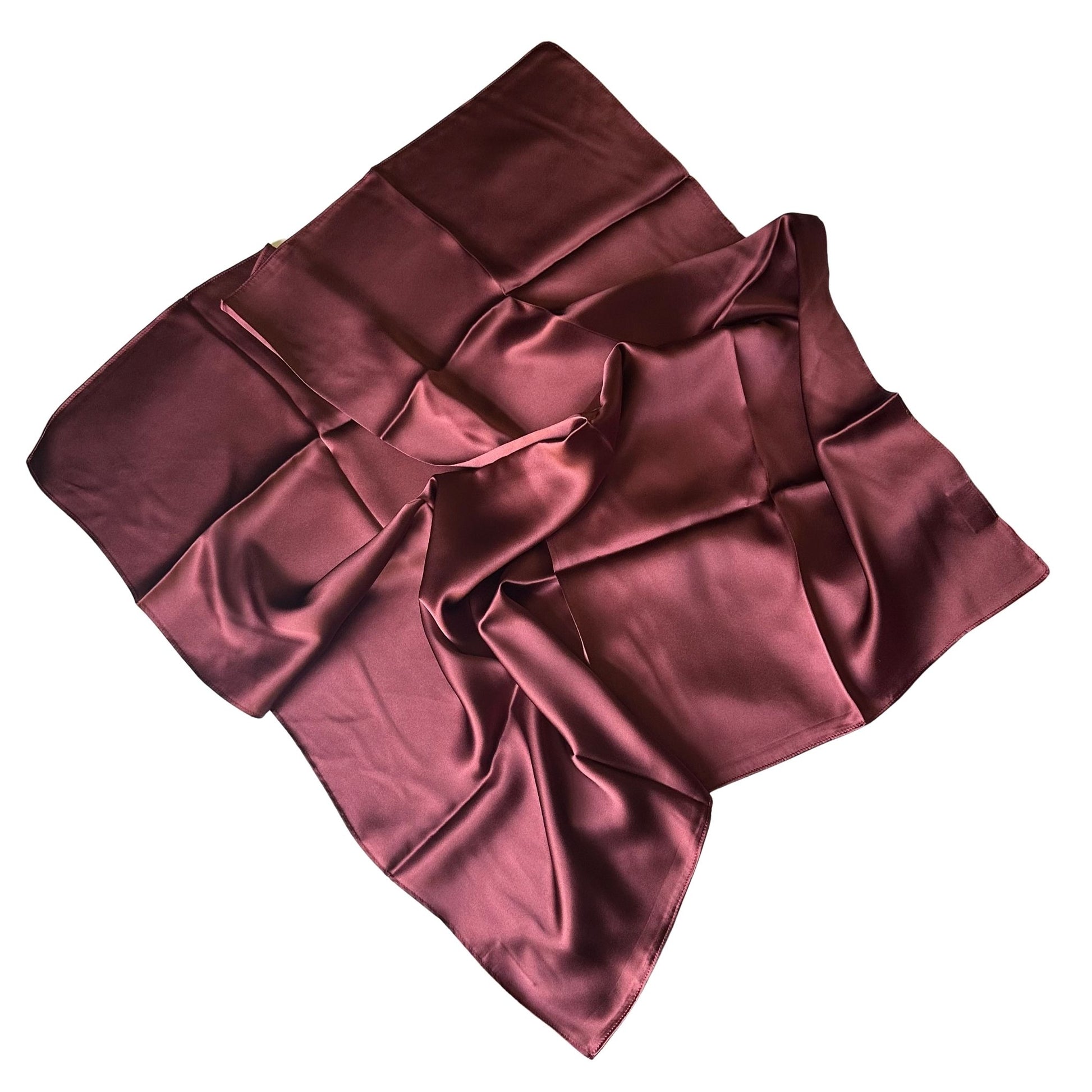 A square silk scarf in a deep chocolate burgundy color, styled with elegant folds on a solid white background.